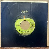 Front view of Apple 45rpm record in black Apple sleeve showing green apple label and catalogue number 1829