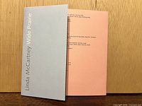 Front view of tri-fold sleeve closed, showing blue panel with white vertical text "Linda McCartney Wide Prairie".