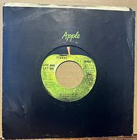Front of record in black Apple sleeve showing label