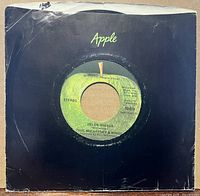 Front of 7-inch single in black Apple sleeve showing A-side label