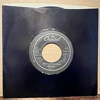 7-inch single in black sleeve front view