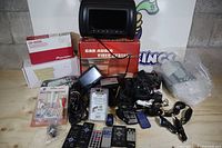 Overall view of all electronics, boxes and cables in lot