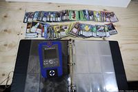 Binder open with OverWorld device and spread of Chaotic cards