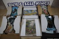 Group shot of six boxed collector plates showing subjects and packaging