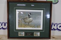 Framed print with mat, stamps, plaque visible