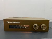 Front view of Heathkit BC-1A radio showing illuminated dial and knobs
