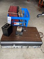 Entire lot showing receiver, crate of media, pencil sharpener, speaker