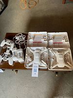 Overview of two drones in cases with controllers, batteries and cable