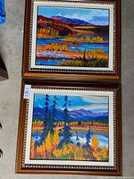 Both framed landscape paintings side by side