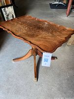Top view showing scalloped mahogany-grain surface and pedestal base