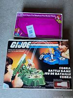 Front of both boxes: GI Joe Cobra Battle Game and Super-Fun Telephone