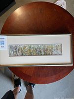 Full view of framed artwork on table