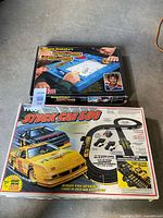 Both boxed games: Gretzky Turbo Hockey on top of Tyco Stock Car 500