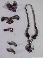 Entire lot showing necklace, cuff bracelet, two brooches and pair of earrings