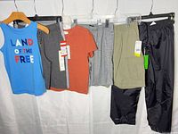 Group of five boys clothing items hanging