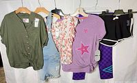 Group shot of all six clothing items hanging