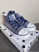 Pair of sneakers on box angled front view