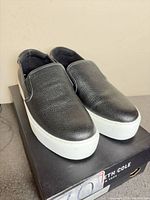 Three-quarter view of both loafers on box