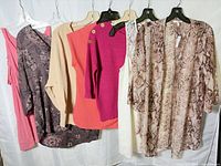 Group shot of all six tops on hangers