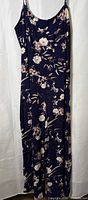 Full front view of navy floral jumpsuit hanging