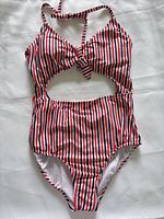 Front view of striped one-piece swimsuit showing cut-out design and halter straps