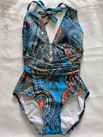 Front view of paisley print one-piece swimsuit showing deep V neckline and halter ties