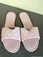 Top view of both sandals showing quilted straps and triangular logo