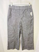Full front view of grey cropped pants hanging