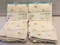 Two packaged pairs of Uniqlo baby floral leggings front view