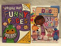 Front covers of both sticker books side by side