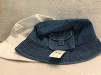 Denim and white bucket hats side by side