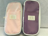 Front view of both pencil cases showing colors, label, and exterior pockets