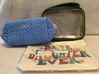 All three pouches displayed: blue quilted, green clear-window, canvas printed