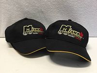 Front view of two caps showing logo and yellow trim