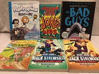 All six books laid out front covers visible