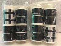 Eight rolls of black roadway tape sealed in two plastic bags