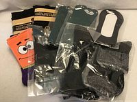 Group shot of all nine packaged socks and tights