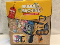 Front of boxed bubble machine showing product image and features