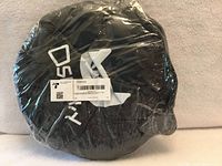 Sealed package showing Dsumky cat tunnel folded in circular black pouch with barcode label