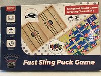 Front of sealed Fibow Fast Sling Puck Game box showing game images and age/player information