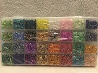 Front view of sealed organizer showing 32 coloured bead compartments