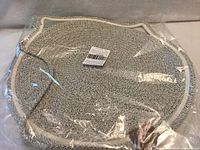 Mat in sealed plastic packaging with barcode label visible