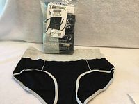 Sealed Wirarpa bag and one displayed black high waist brief