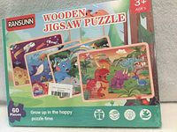 Front of sealed RANSUNN wooden jigsaw puzzle 4-pack showing sample images and age/piece count information
