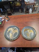 Both round calla lily plaques displayed on table surface