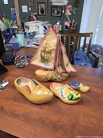 Group shot of clog sailboat with three additional clogs on tabletop