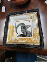 Plate in presentation box showing front design and gold detailing