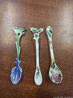 Three decorative porcelain spoons laid out on table