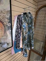 All six tops hanging on slat wall