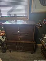 Front view of stacked dresser showing drawers and doors